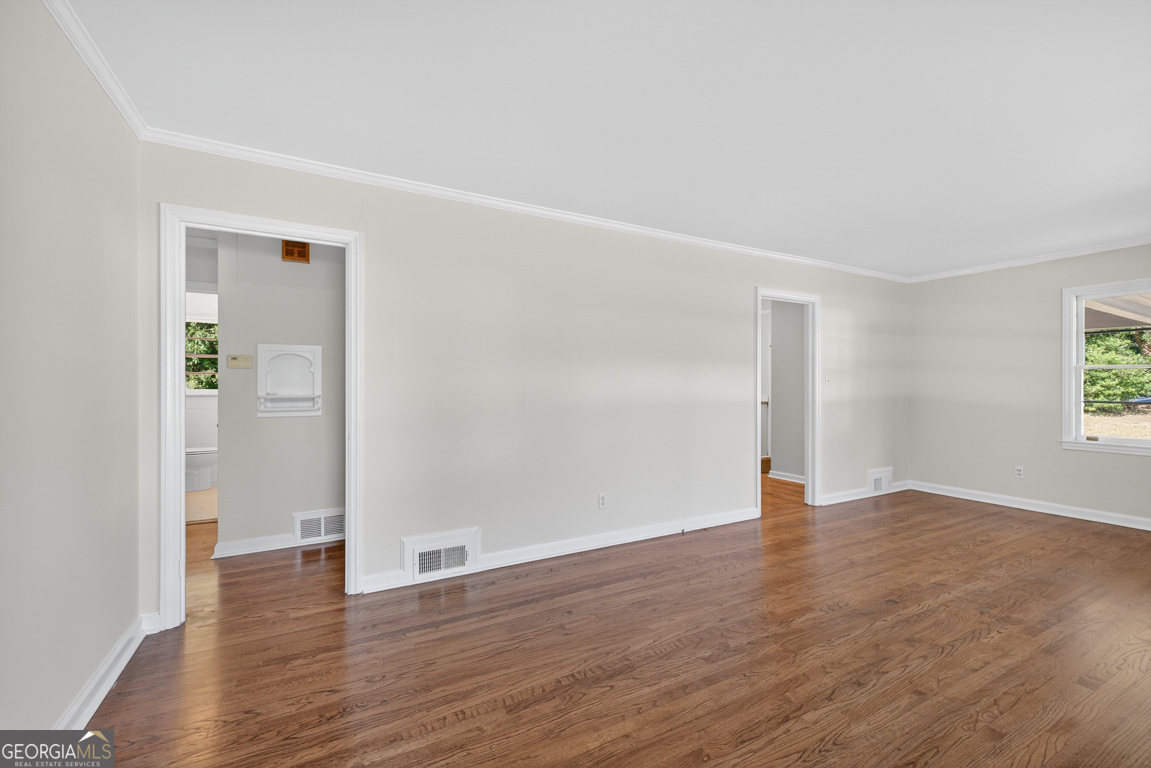 352 3rd Avenue Winder, GA 30680 - Photo 7 of 33 a view of an empty room with wooden floor and a window