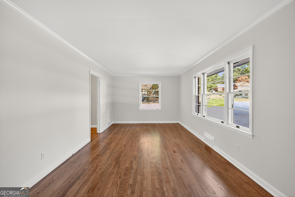 352 3rd Avenue Winder, GA 30680 - Photo 8 of 33 an empty room with wooden floor and windows