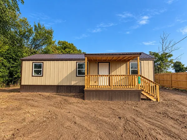 a view of a house with a wooden deck