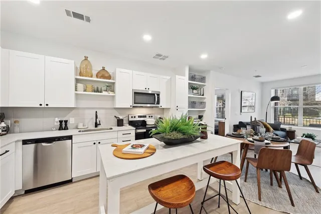 a kitchen with a table and chairs in it