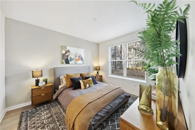 a bedroom with furniture and a potted plant