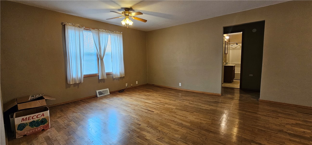 206 East Fifth Street St. Peter, IL 62880 - Photo 7 of 23 an empty room with wooden floor closet and windows