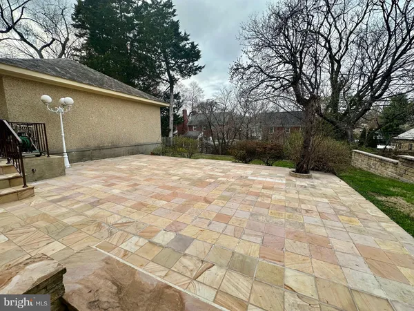 a view of a backyard with large trees