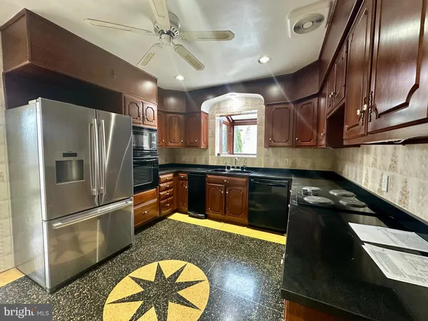 a kitchen with granite countertop stainless steel appliances and wooden cabinets