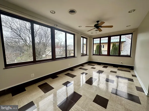 a view of a room with wooden floor and a window