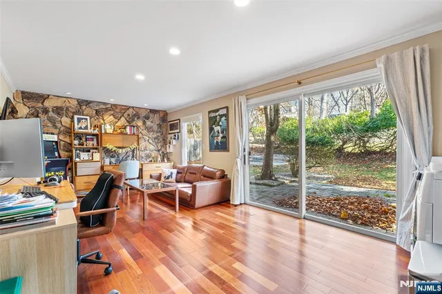 a bed room with furniture and floor to ceiling window