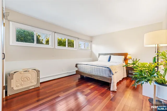 a bedroom with a bed and a potted plant