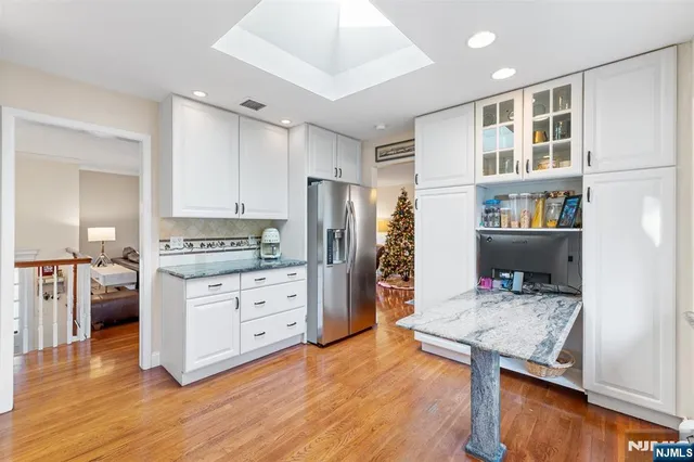 a kitchen with a refrigerator and a stove top oven
