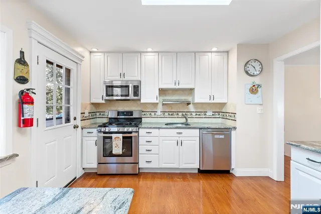 a kitchen with stainless steel appliances granite countertop a stove and a refrigerator