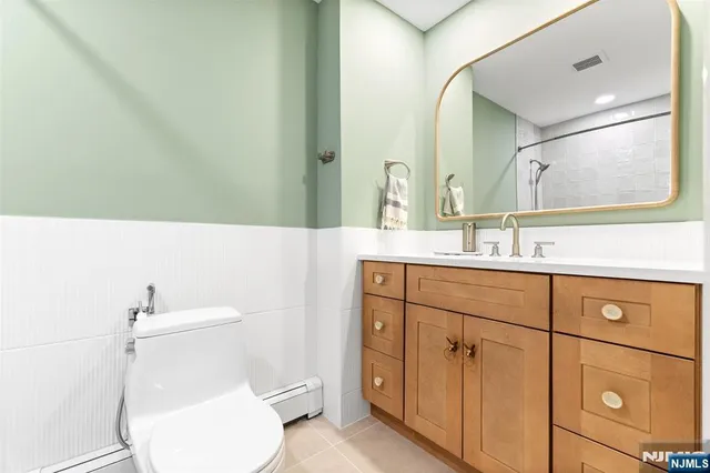 a bathroom with a sink toilet and mirror