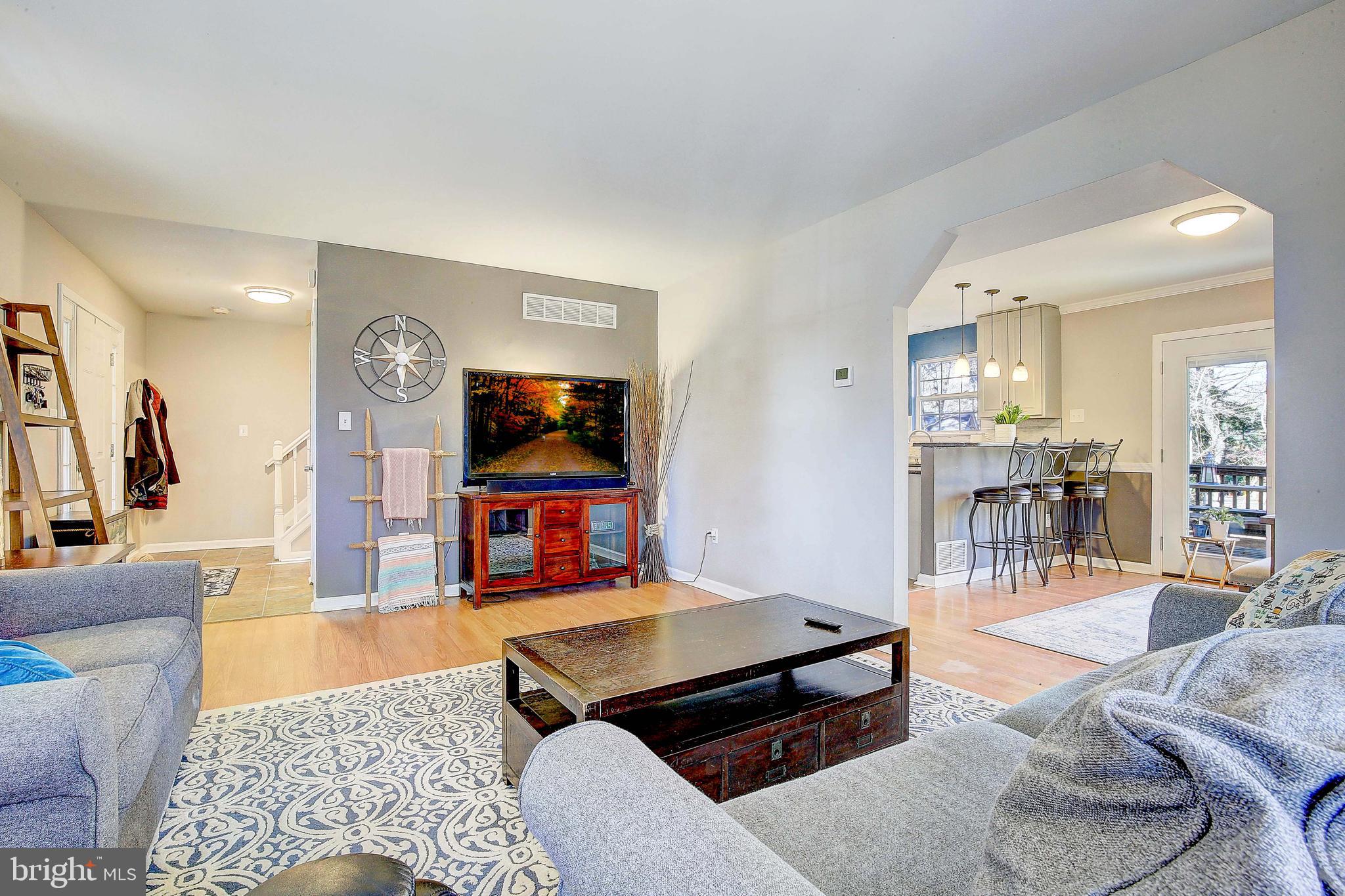 342 Metropolitan Boulevard Pasadena, MD 21122 - Photo 11 of 47 a living room with furniture and a flat screen tv