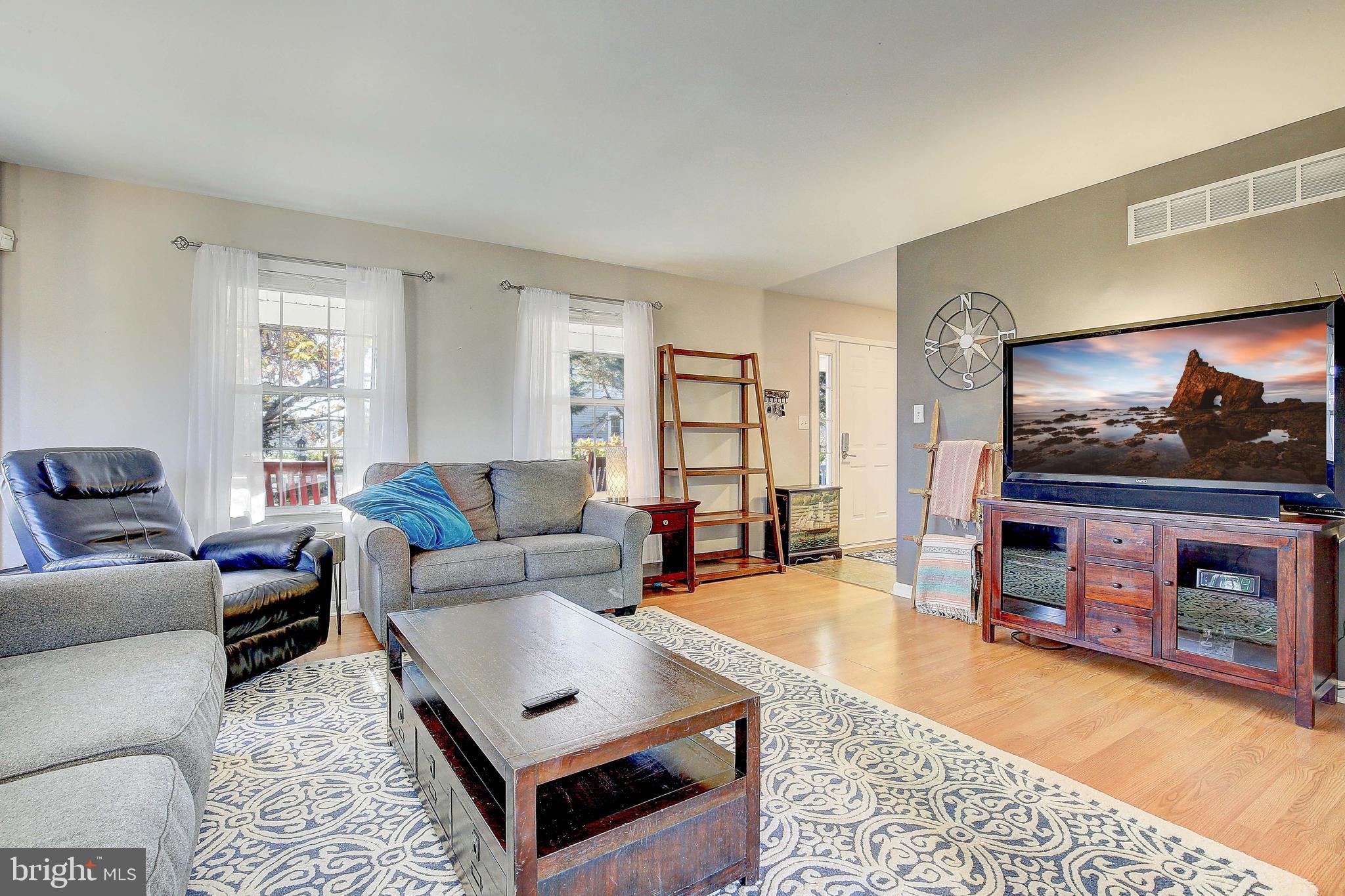 342 Metropolitan Boulevard Pasadena, MD 21122 - Photo 12 of 47 a living room with furniture and a flat screen tv