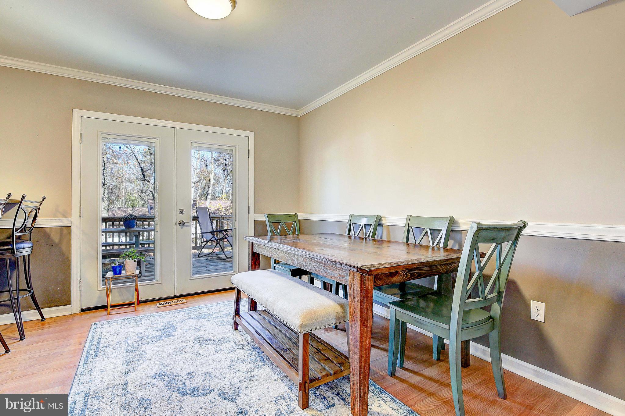 342 Metropolitan Boulevard Pasadena, MD 21122 - Photo 13 of 47 a view of a dining room with furniture and a window