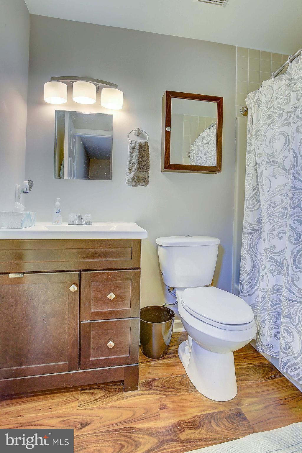 342 Metropolitan Boulevard Pasadena, MD 21122 - Photo 18 of 47 a bathroom with a toilet sink and mirror