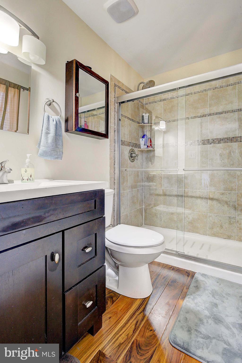 342 Metropolitan Boulevard Pasadena, MD 21122 - Photo 22 of 47 a bathroom with a sink a toilet and shower