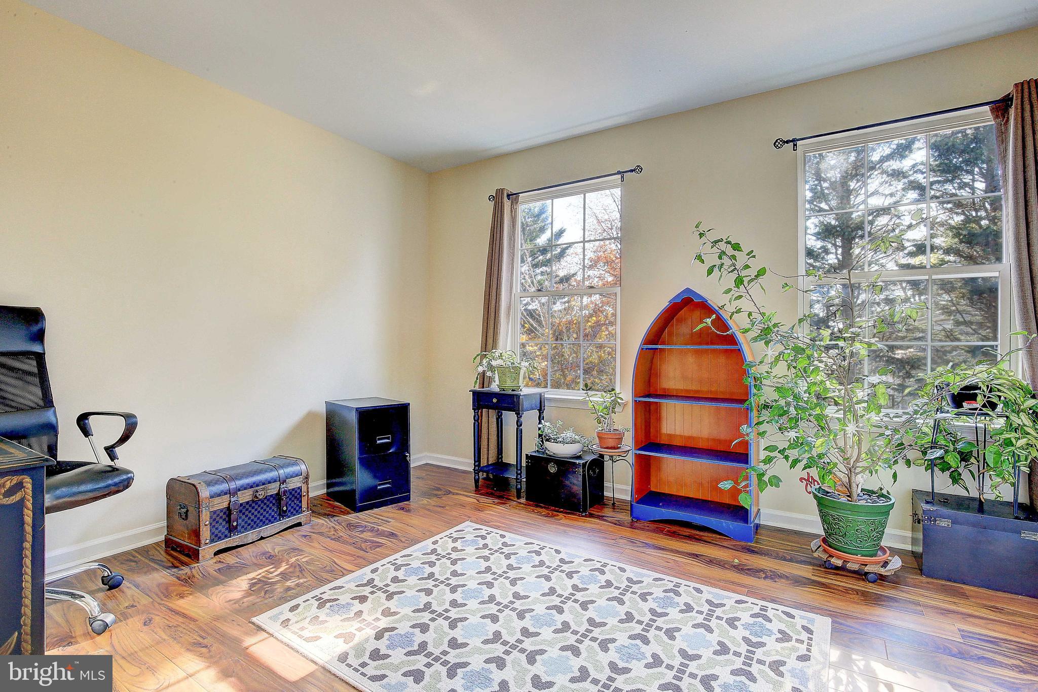 342 Metropolitan Boulevard Pasadena, MD 21122 - Photo 24 of 47 a living room with furniture a flat screen tv and a lamp