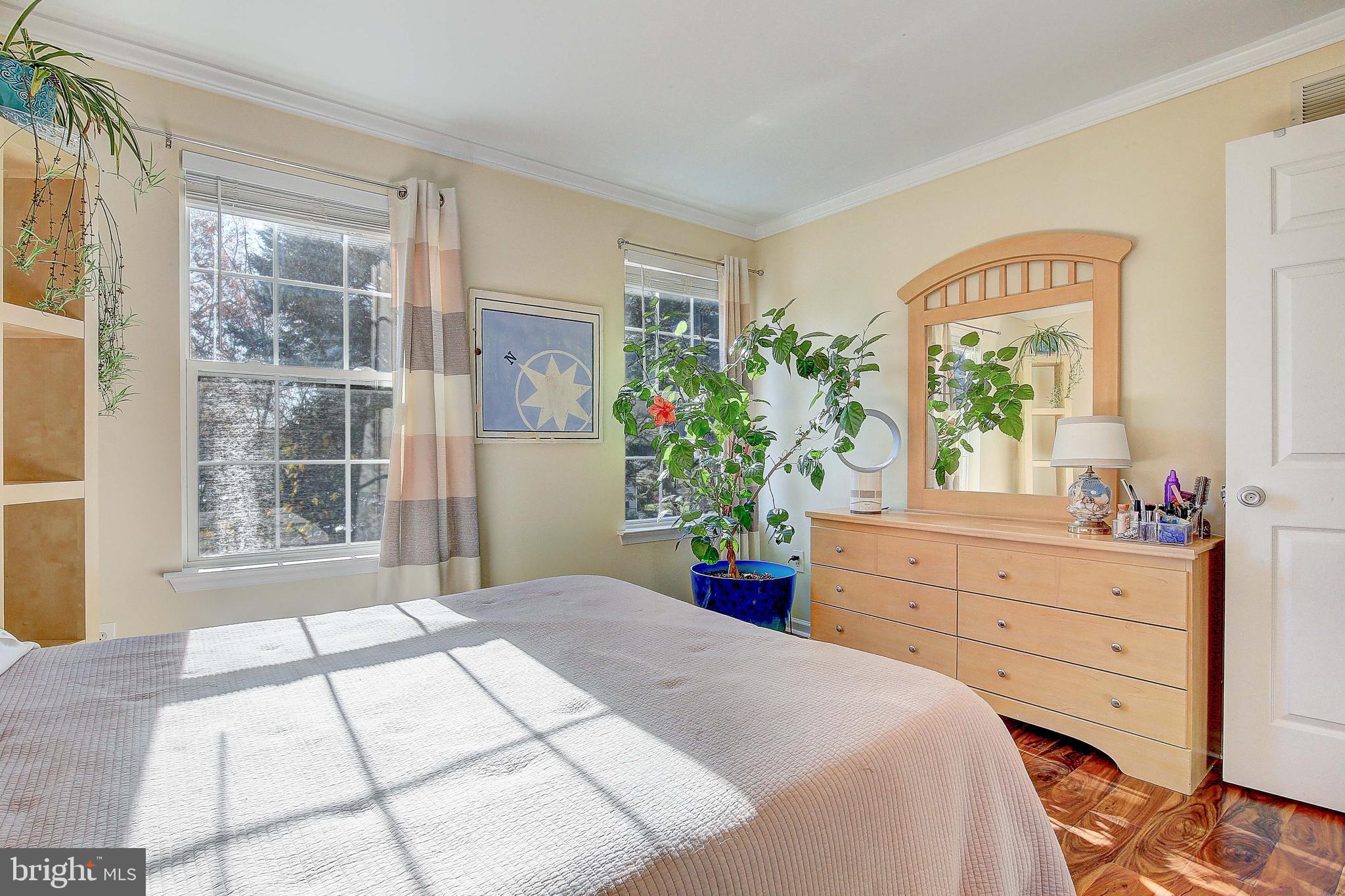 342 Metropolitan Boulevard Pasadena, MD 21122 - Photo 26 of 47 a bedroom with a bed potted plant and a large window