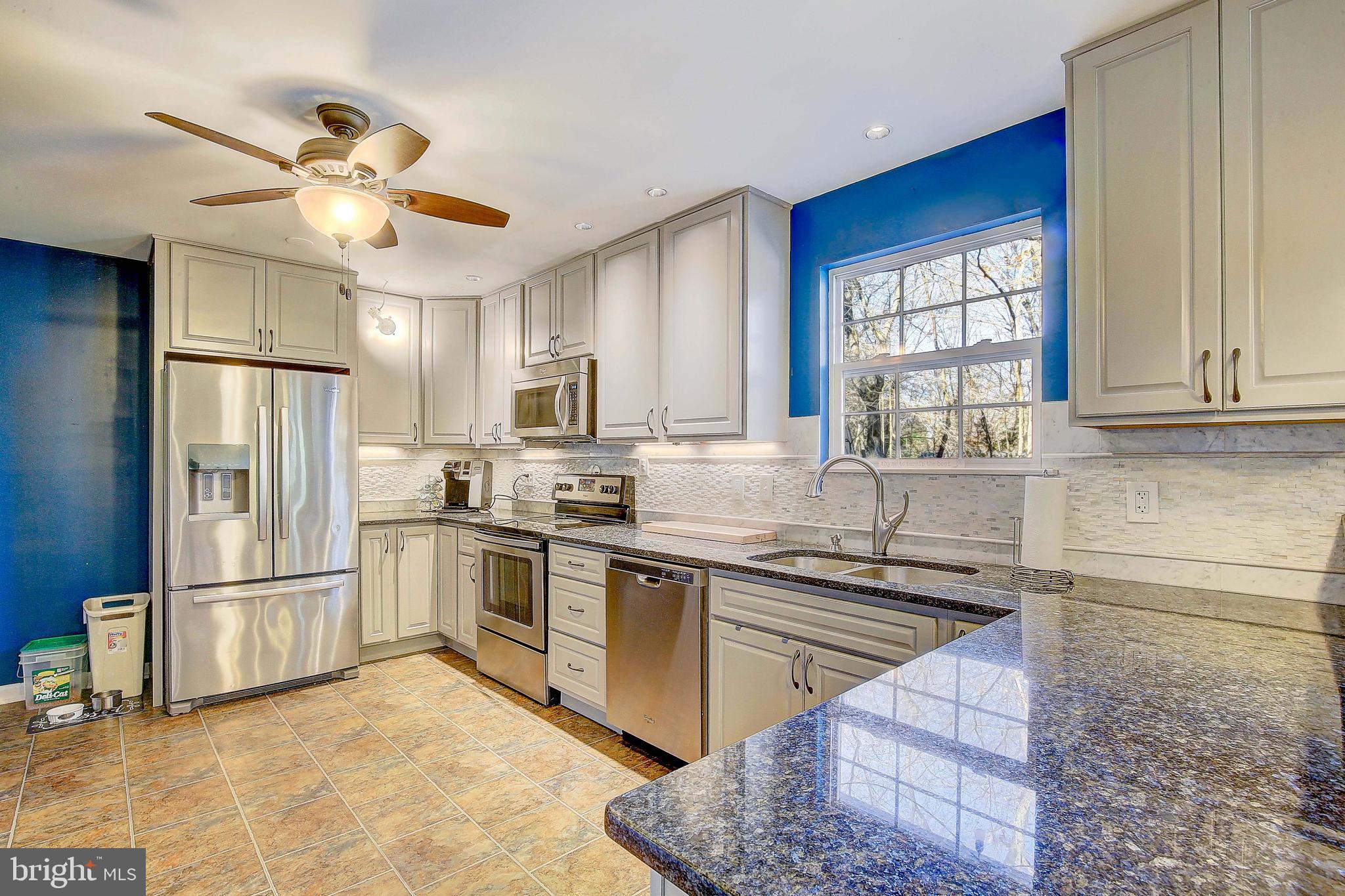 342 Metropolitan Boulevard Pasadena, MD 21122 - Photo 8 of 47 a kitchen with granite countertop a sink appliances cabinets and a counter top space