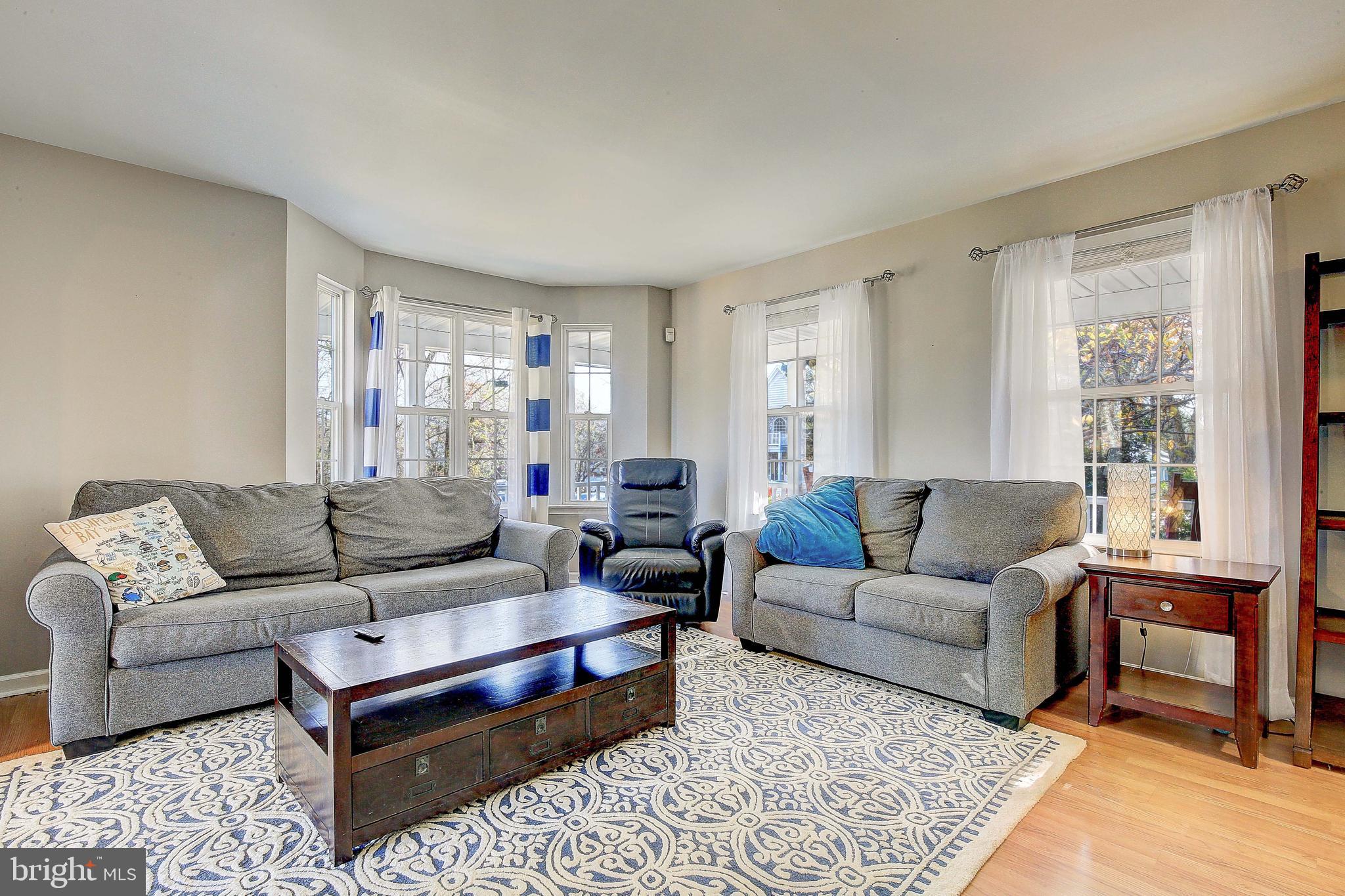 342 Metropolitan Boulevard Pasadena, MD 21122 - Photo 10 of 47 a living room with furniture and a couch