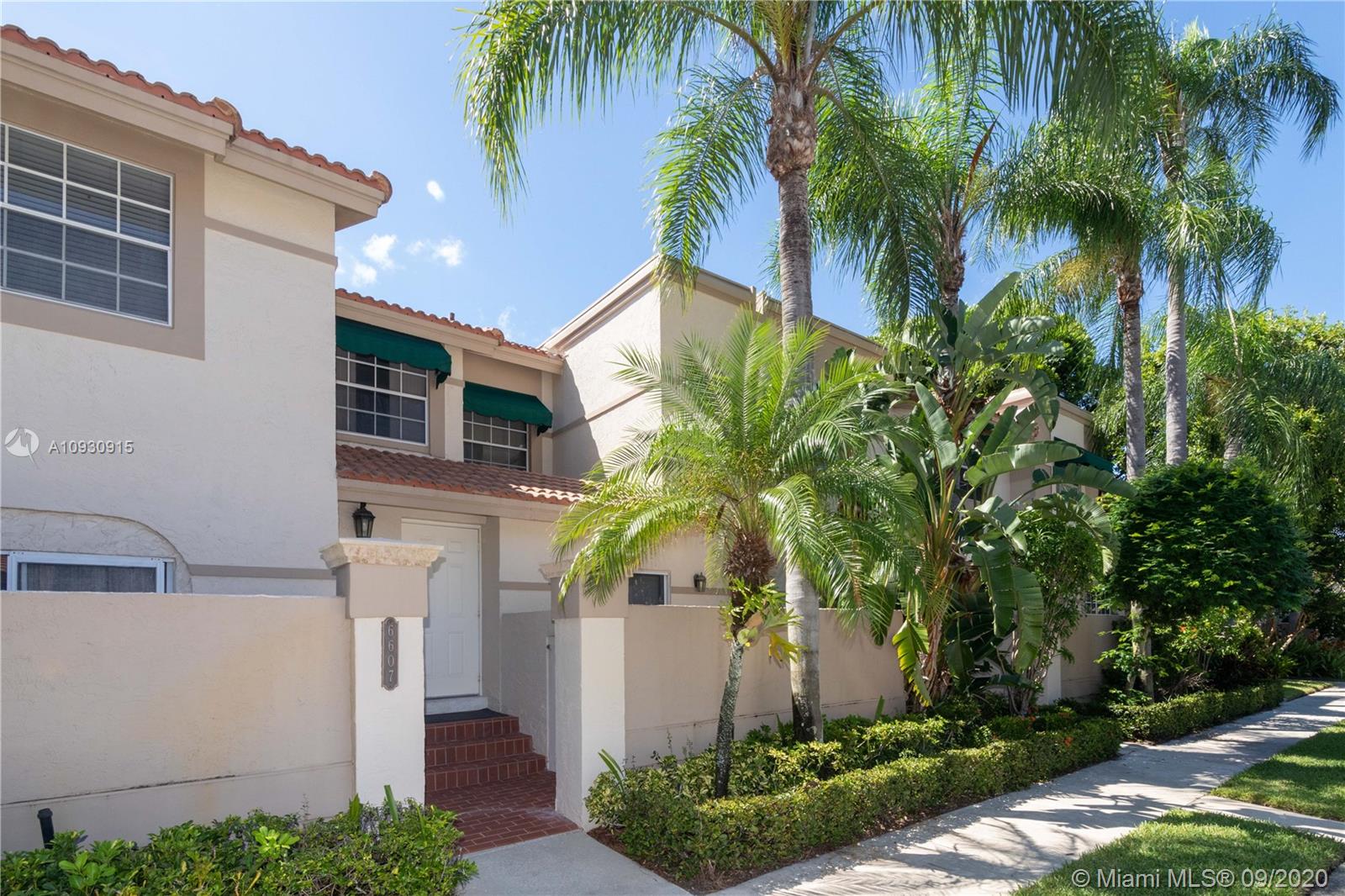 6607 Via Regina Boca Raton, FL 33433 - Photo 1 of 40 a front view of a house with a yard