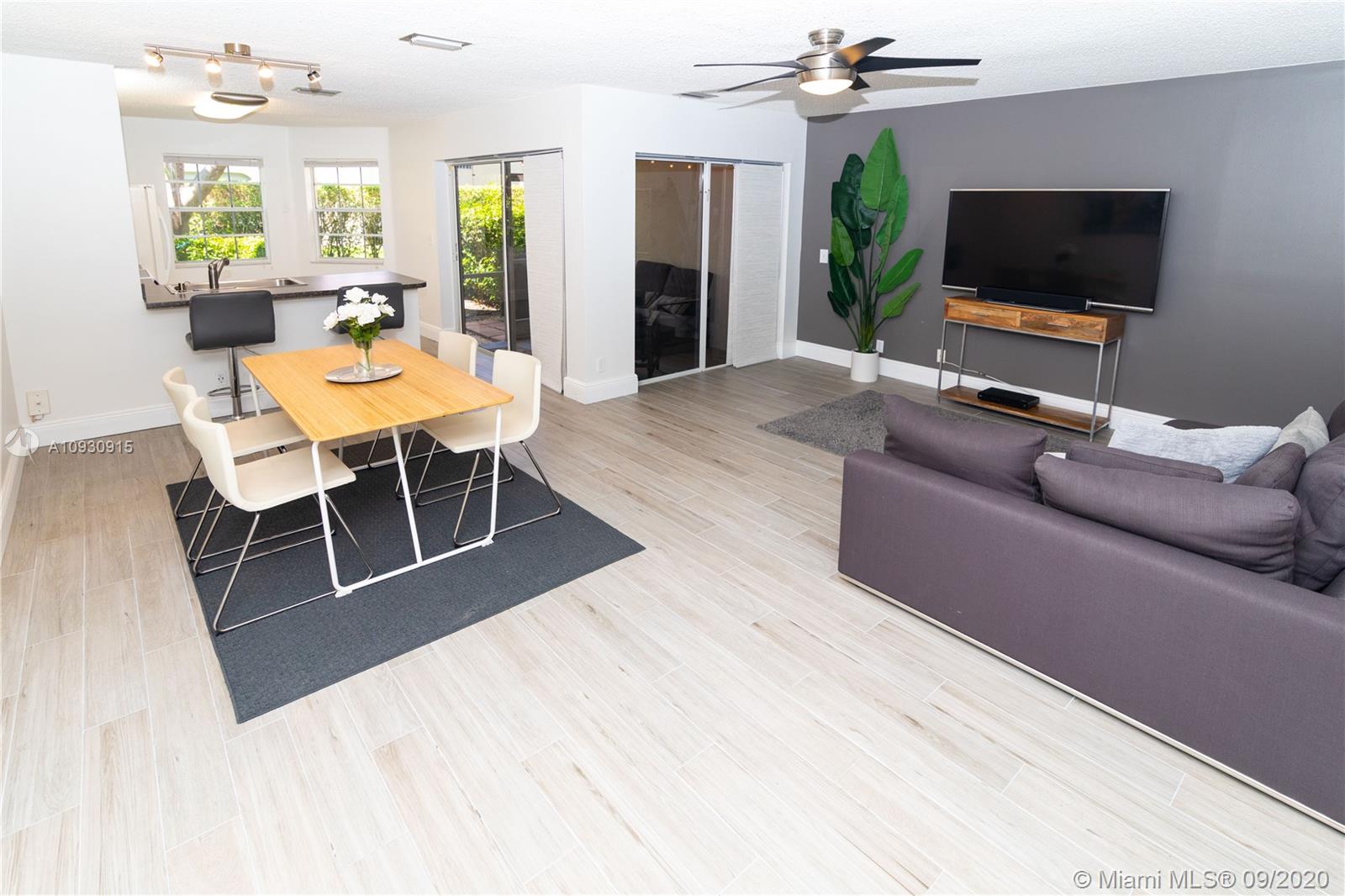 6607 Via Regina Boca Raton, FL 33433 - Photo 2 of 40 a living room with furniture and a flat screen tv
