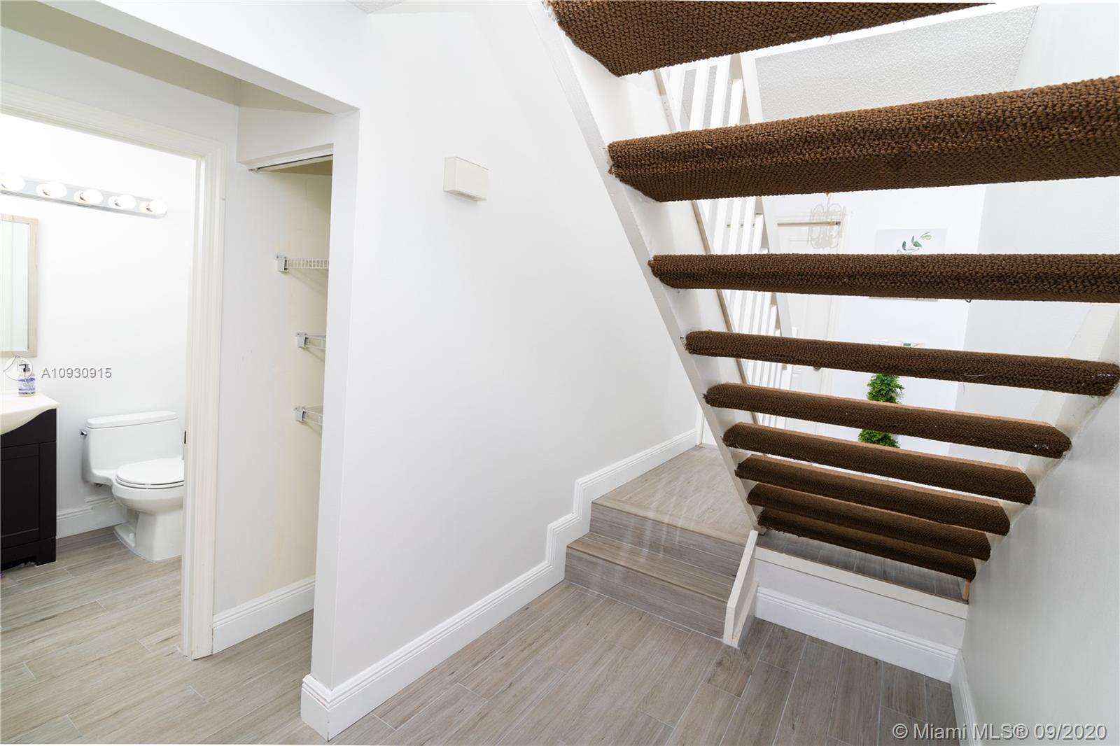 6607 Via Regina Boca Raton, FL 33433 - Photo 12 of 40 a view of a hallway with wooden floor and staircase