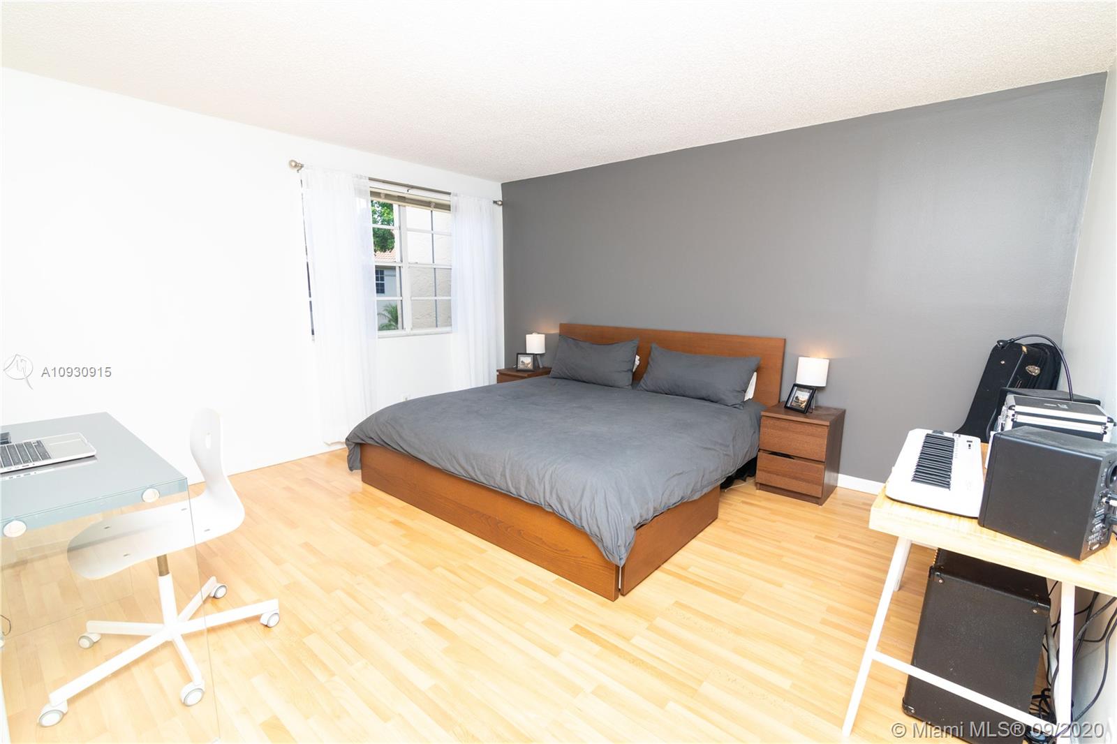 6607 Via Regina Boca Raton, FL 33433 - Photo 21 of 40 a bedroom with a bed and wooden floor