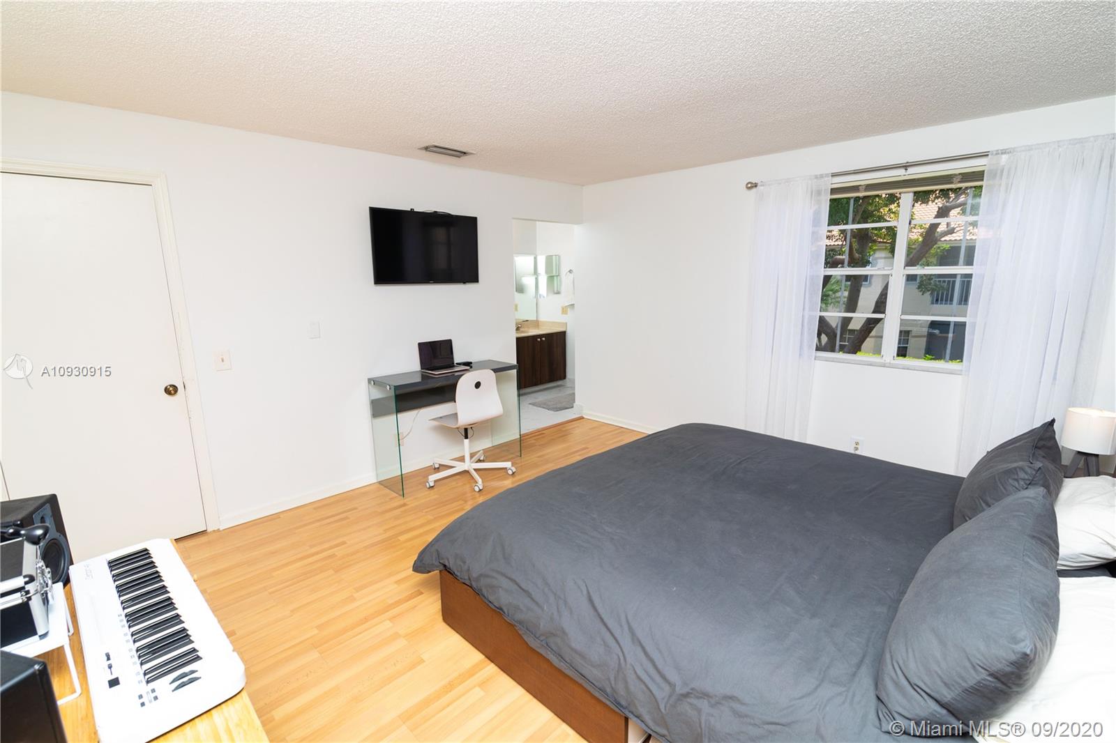 6607 Via Regina Boca Raton, FL 33433 - Photo 23 of 40 a bedroom with a bed and a flat screen tv