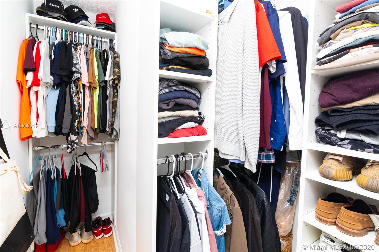 6607 Via Regina Boca Raton, FL 33433 - Photo 25 of 40 a view of walk in closet with clothes and shoes