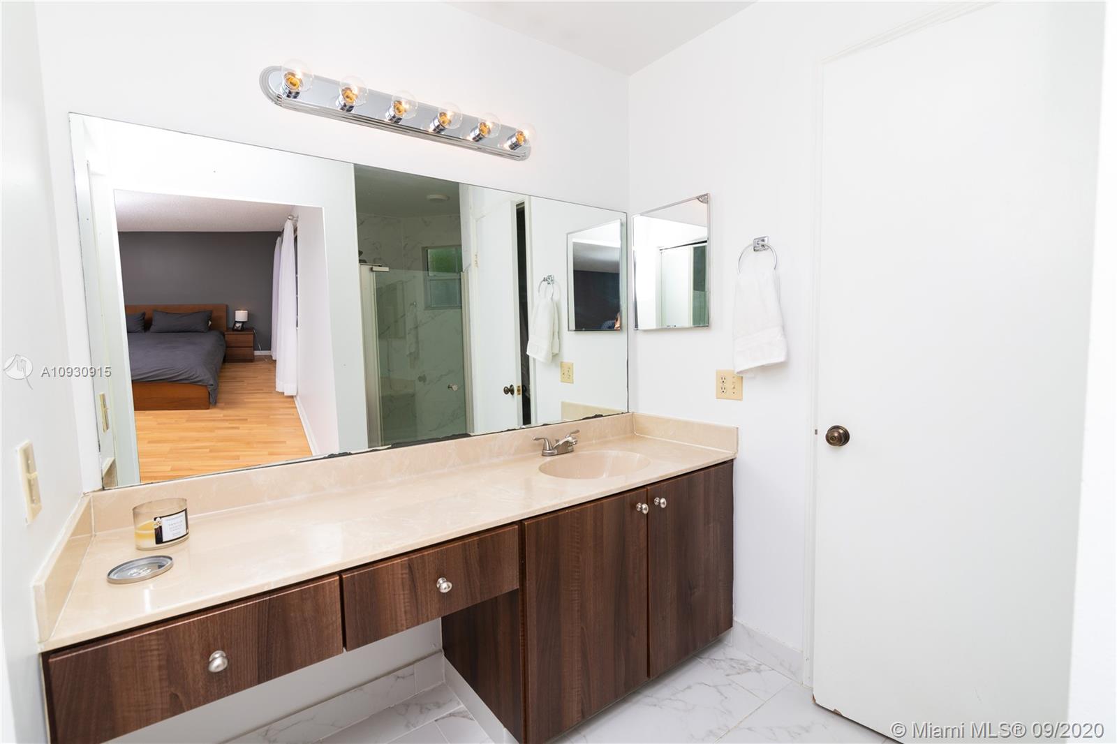 6607 Via Regina Boca Raton, FL 33433 - Photo 26 of 40 a bathroom with a sink and a mirror