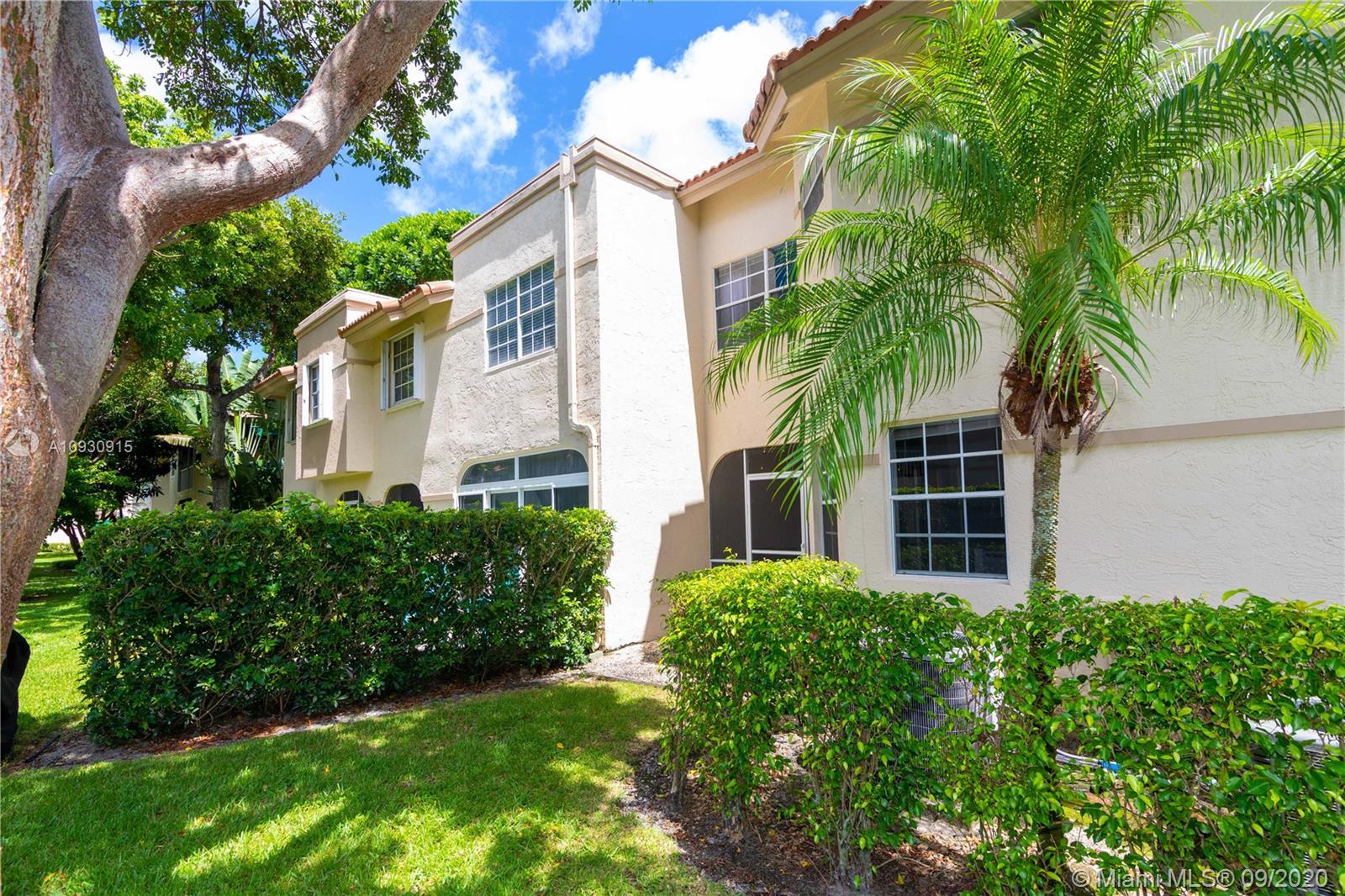 6607 Via Regina Boca Raton, FL 33433 - Photo 33 of 40 front view of a house with a garden