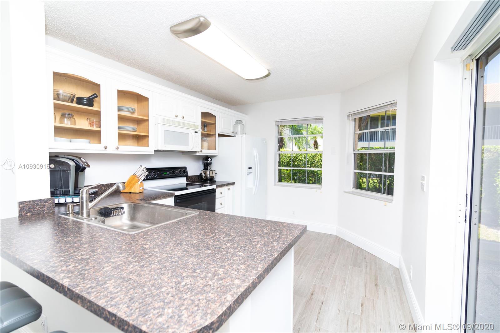 6607 Via Regina Boca Raton, FL 33433 - Photo 5 of 40 a kitchen with a sink appliances and a counter top space