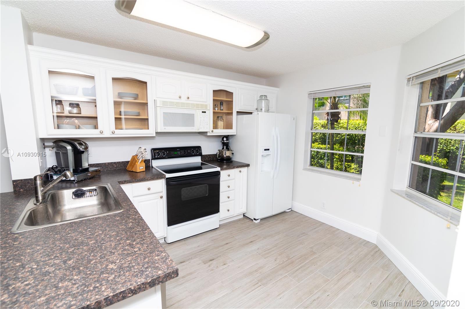 6607 Via Regina Boca Raton, FL 33433 - Photo 6 of 40 a kitchen that has a sink and a stove