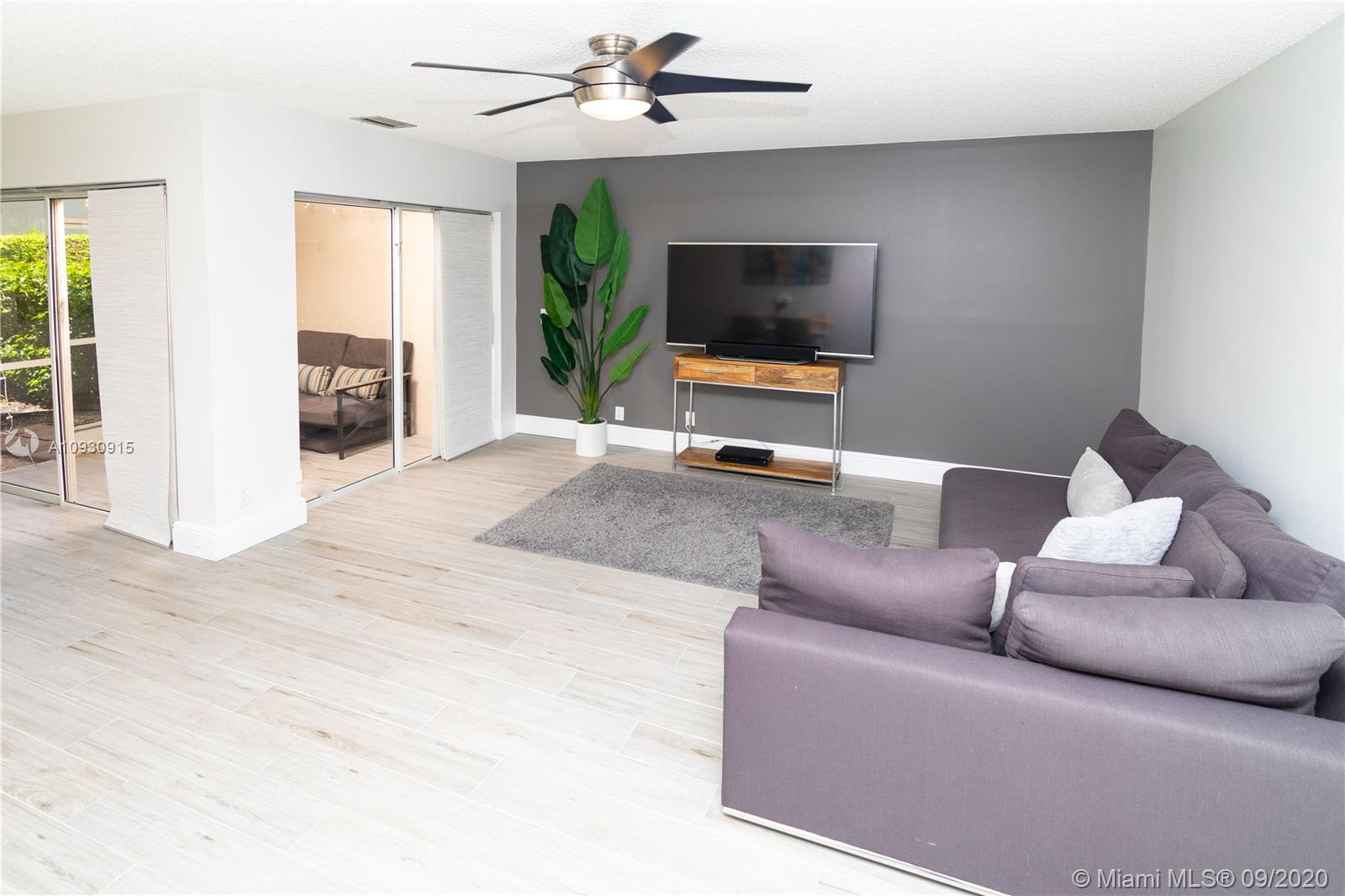 6607 Via Regina Boca Raton, FL 33433 - Photo 10 of 40 a living room with furniture and a flat screen tv