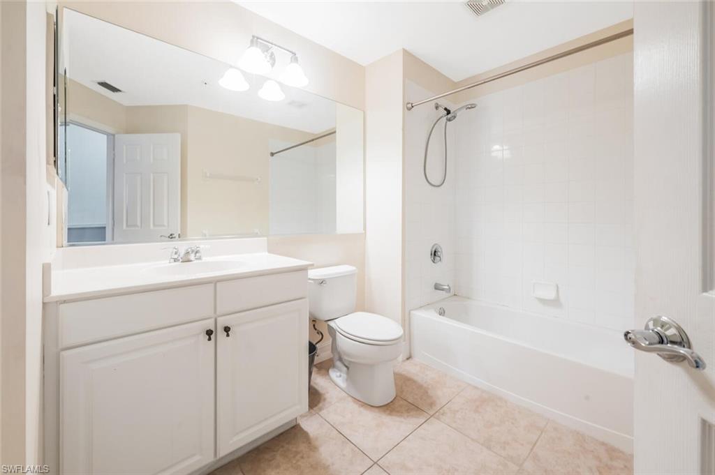 15845 Marcello Circle, Unit 83 Naples, FL 34110 - Photo 13 of 15 Full bathroom with vanity, tile patterned flooring, tiled shower / bath, and toilet
