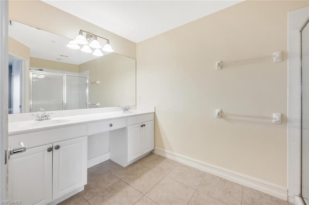 15845 Marcello Circle, Unit 83 Naples, FL 34110 - Photo 10 of 15 Bathroom with vanity, tile patterned floors, and a shower with door