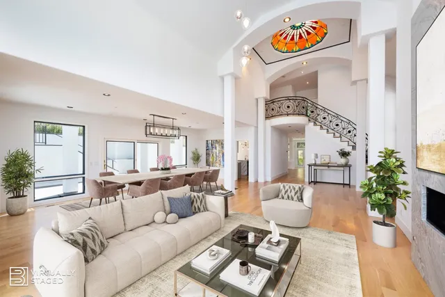 a living room with fireplace furniture and a large window