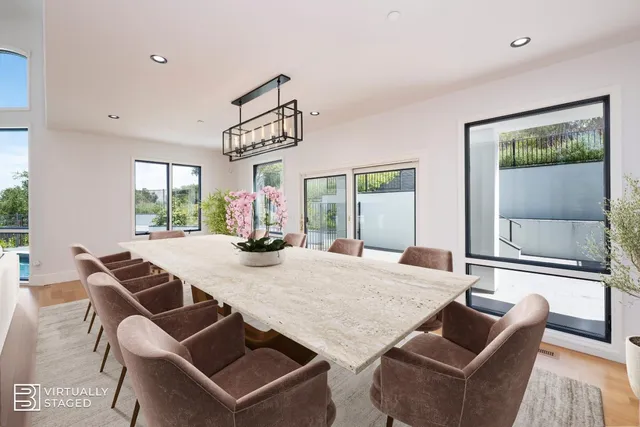 a living room with furniture and a dining table with wooden floor