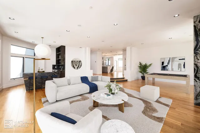 a bed sitting in a spacious bedroom next to a window