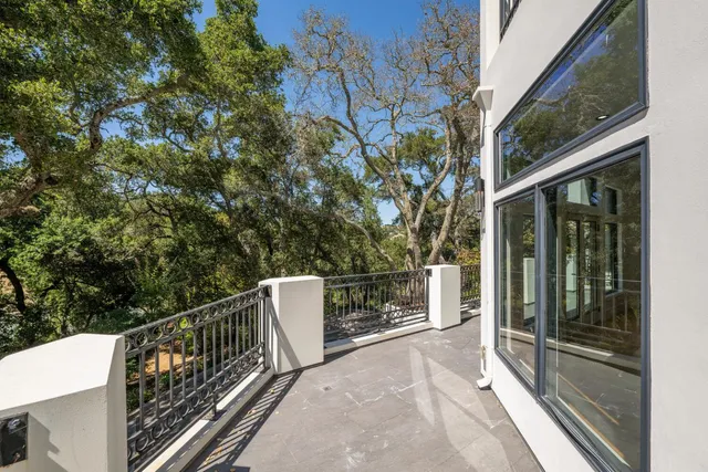 a view of a house with swimming pool and sitting area