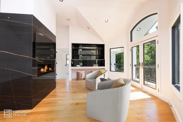 an aerial view of residential house with outdoor space and trees all around