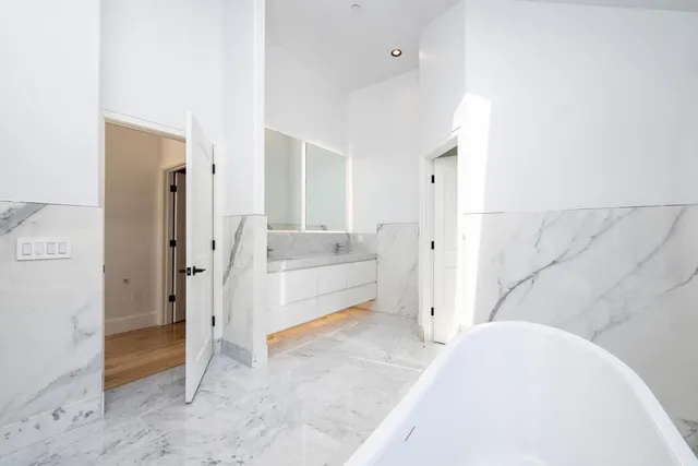 a front view of a house with a yard and tree s