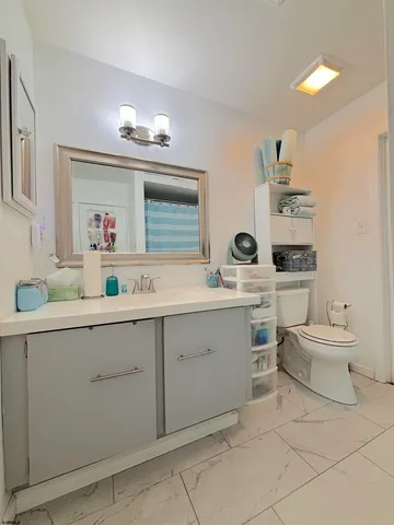 a bathroom with a sink vanity and mirror