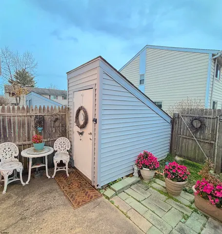 a view of a chairs and table in backyard