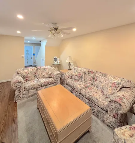 a living room with a bed and dresser