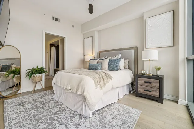 a bed room with a bed and a potted plant