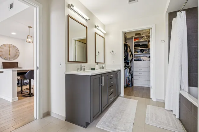 a bathroom with a double vanity sink and a mirror