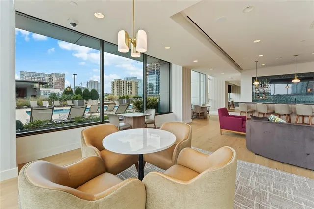 a view of a living room with furniture and a floor to ceiling window