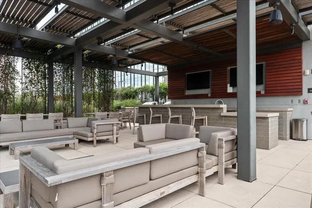 a view of a patio with couches table and chairs and potted plants