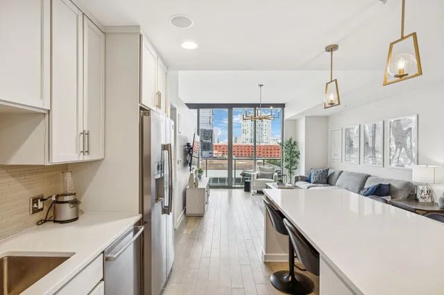 a kitchen with a sink a stove and chairs